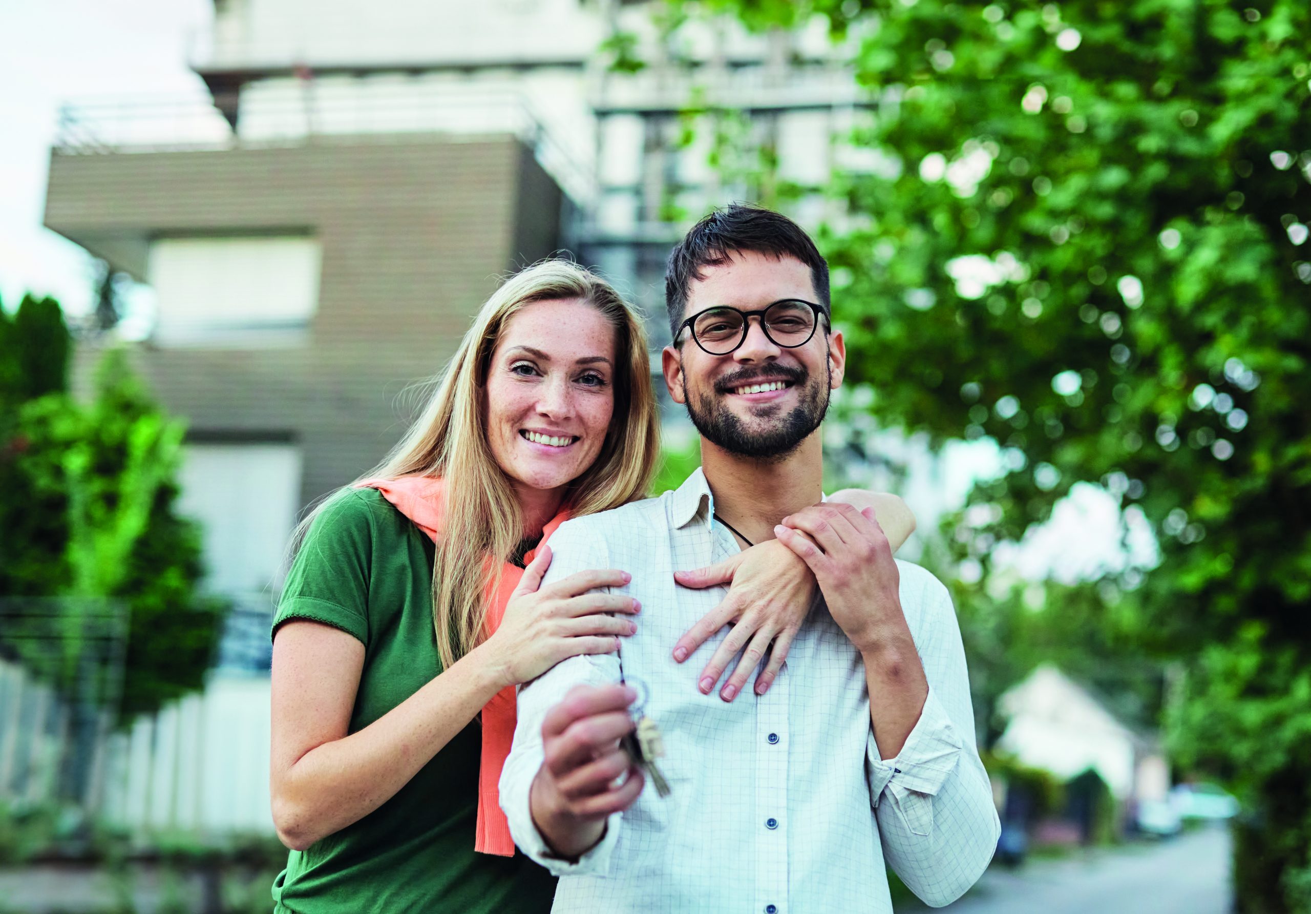 Portrait,Of,A,Happy,Young,Couple,Standing,In,Front,Of